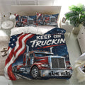 Trucker duvet cover bedding set in a modern bedroom featuring repeated red semi trucks and navy patriotic artwork