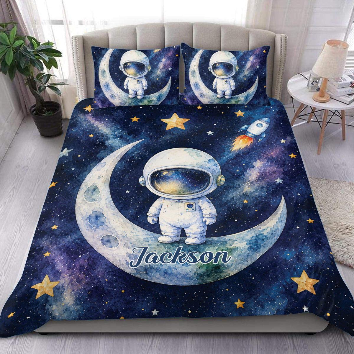 Astronaut duvet cover set displayed on a bed with moon, rocket, stars, and deep blue galaxy artwork