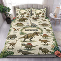 Dinosaur duvet cover set styled on a bed with realistic prehistoric creatures and tropical foliage