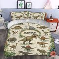 Dinosaur duvet cover set in a bedroom featuring tropical foliage, labeled dinosaur artwork, and neutral tones