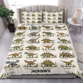 Dinosaur alphabet duvet cover set displayed on a bed with illustrated prehistoric animals and leafy accents