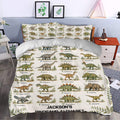 Dinosaur alphabet bedding styled in a bedroom with colorful illustrated prehistoric animals and botanical borders