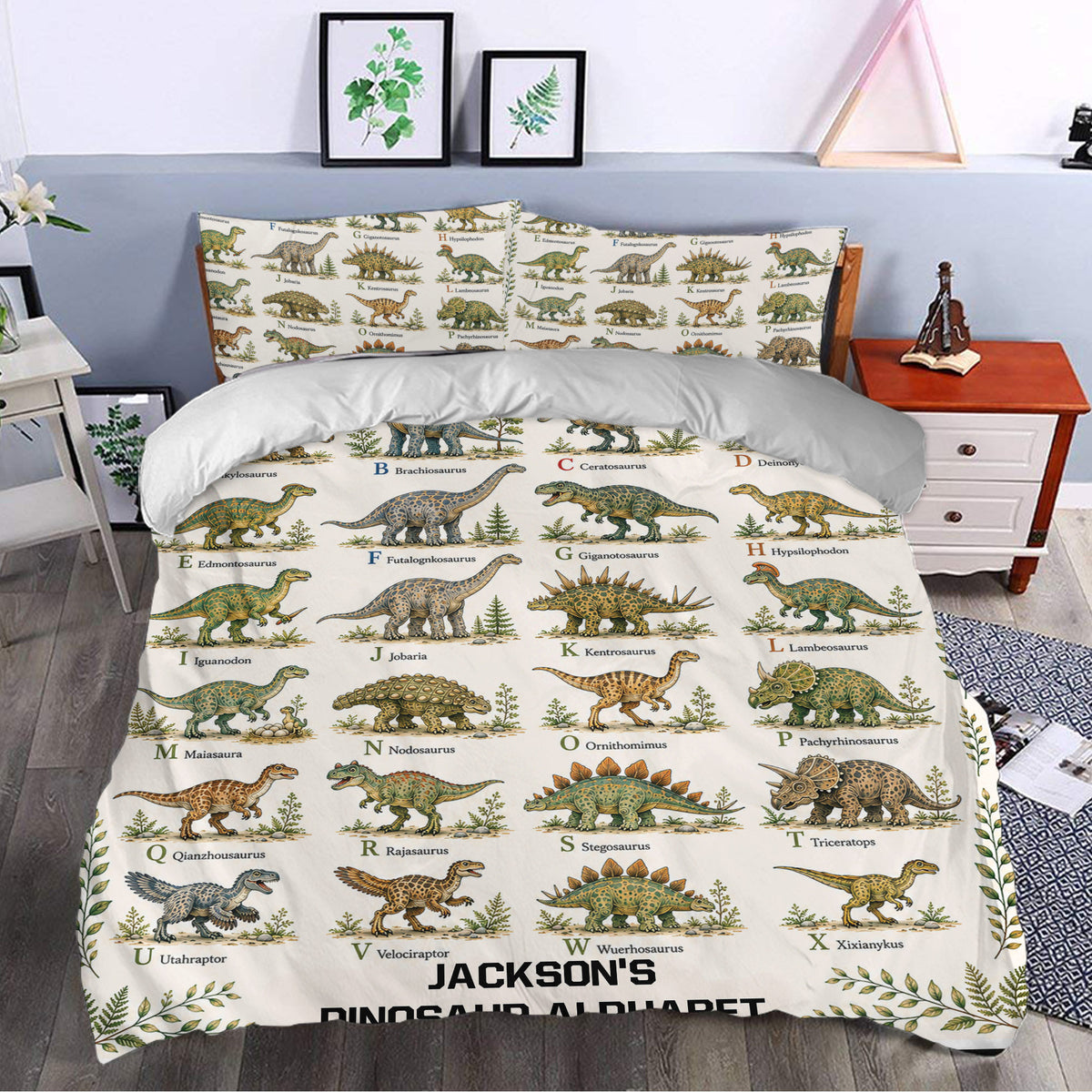 Dinosaur alphabet bedding styled in a bedroom with colorful illustrated prehistoric animals and botanical borders