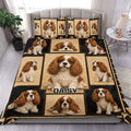 Cavalier King Charles duvet cover set displayed on a bed with repeated dog portraits in tan and black
