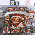 Brittany Spaniel Christmas duvet cover styled in a bedroom with red tartan, snow, and holiday scenes