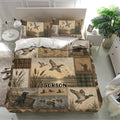 Rustic duck hunting bedding set displayed in a bright bedroom with mallards, wetlands, and hunting lodge artwork