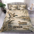 Duck hunting duvet cover set displayed on a bed with mallard ducks, marsh water, reeds, and rustic artwork