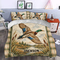 Rustic duck hunting bedding styled in a bedroom with mallard artwork, wetland scenery, and plaid accents