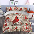 Cardinal duvet cover bedding displayed in a bedroom with red bird artwork and snowy woodland accents