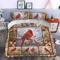 Cardinal duvet cover set styled in a bedroom with red birds, snowy branches, berries, and botanical panels