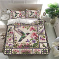 Colorful hummingbird duvet cover set presented in a bright bedroom with floral matching pillowcases