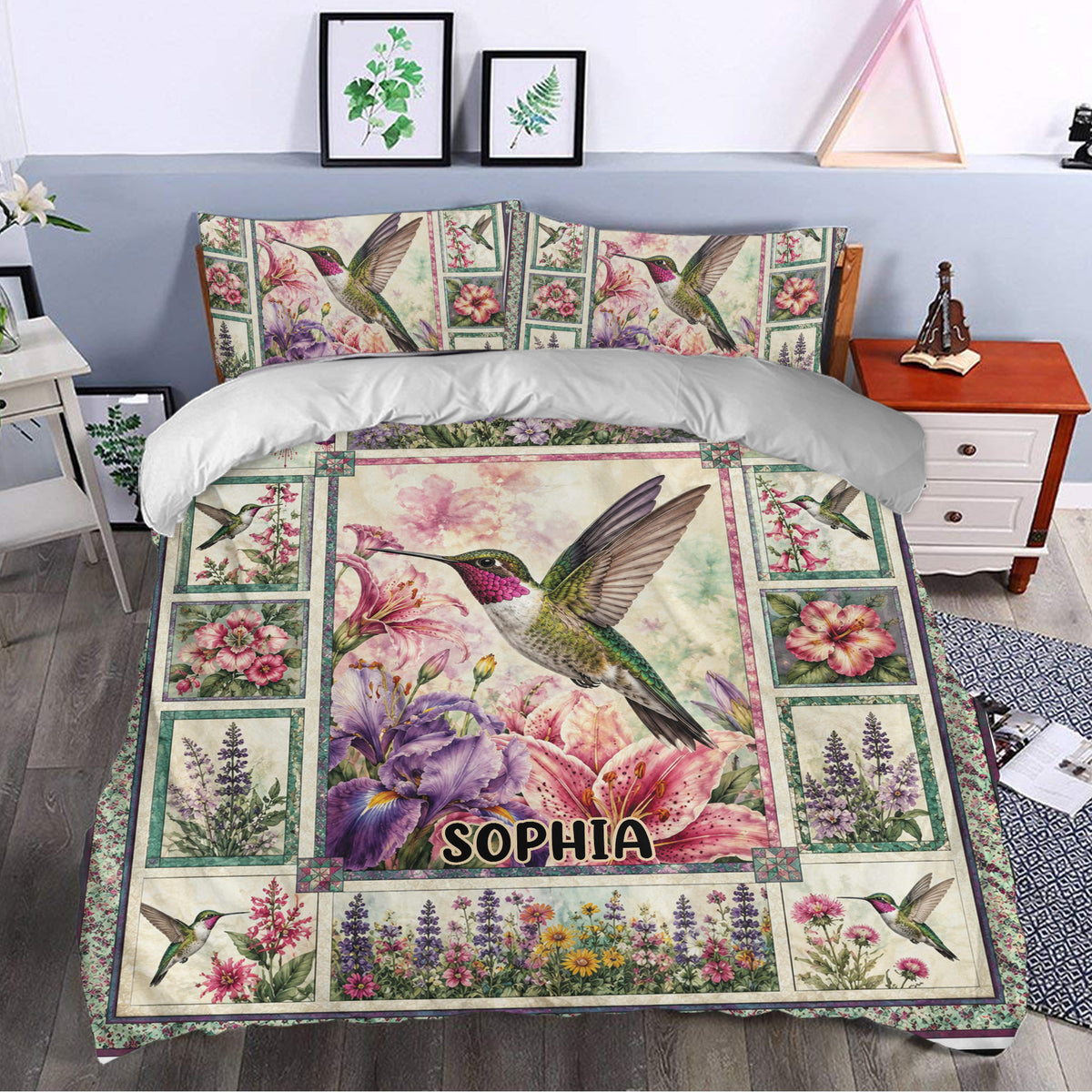 Hummingbird bedding styled in a bedroom with pink lilies, purple flowers, and botanical border details