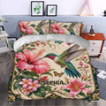 Hummingbird duvet cover set styled in a bedroom with tropical flowers, butterflies, and decorative botanical artwork
