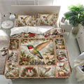 Hummingbird bedding set displayed in a bright bedroom with matching pillows and festive botanical artwork