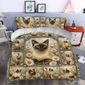 Siamese cat duvet cover styled in a bright bedroom with daisy flowers, butterflies, and vintage botanical artwork