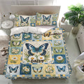Butterfly bedding set with blue butterfly and daisy artwork arranged in a bright botanical bedroom
