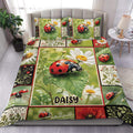 Ladybug duvet cover set displayed on a bed with daisies, green leaves, and botanical patchwork artwork