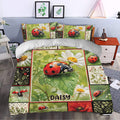 Ladybug duvet cover styled in a bedroom with daisies, leafy panels, red accents, and garden-inspired artwork