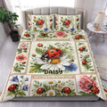 Ladybug duvet cover set displayed on a bed with colorful flowers, greenery, and matching pillowcases