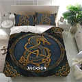 Viking bedding set presented on a modern bed with dark blue Norse knotwork and gold detailing