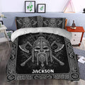 Viking bedding set arranged in a bedroom with a dramatic bearded warrior design, axes, runes, and knotwork borders