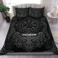 Black Viking duvet cover set with Norse symbols, runes, dragons, and ornate knotwork in a bedroom