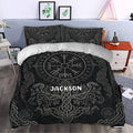 Black Viking duvet cover with runes, knotwork, dragons, and a central Norse compass design on a bed