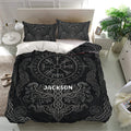 Viking bedding set styled in a modern bedroom with black Norse symbols, dragons, and intricate knotwork