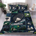 Badminton duvet cover set displayed on a bed with racket, shuttlecock, and deep blue green sports artwork