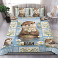 Otter duvet cover set displayed on a bed with daisies, blue water scenes, and botanical border panels