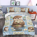 Otter duvet cover styled in a bedroom with matching pillows, daisies, and soft blue decor tones