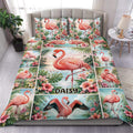 Flamingo duvet cover set displayed on a bed with tropical flowers, palm leaves, and colorful coastal artwork