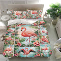 Tropical flamingo bedding set shown in a bright bedroom with matching pillowcases and colorful floral artwork