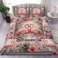 Flamingo duvet cover bedding set displayed on a bed with pink flowers and tropical foliage