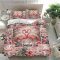 Flamingo bedding set displayed in a bright bedroom with matching pillowcases and tropical flowers