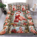 Flamingo duvet cover set displayed on a bed with Christmas trees, ornaments, gifts, and red scarves