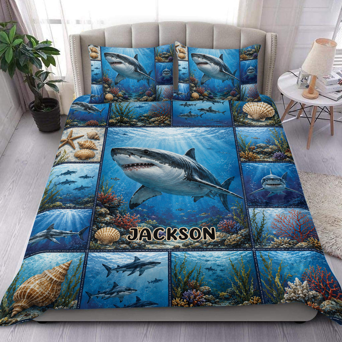 Shark duvet cover set displayed on a bed with blue underwater scenes, coral reefs, shells, and custom lettering