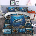 Shark duvet cover bedding set styled in a bedroom with bold ocean artwork, coral reefs, fish, and compass motifs