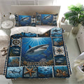 Shark bedding set displayed in a bright bedroom with underwater artwork, matching pillowcases, coral, fish, and nautical details