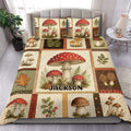 Mushroom duvet cover set displayed on a bed with red caps, woodland leaves, ferns, and rustic patchwork panels