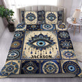 Evil Eye duvet cover set displayed on a bed in navy blue, cream, gold, and turquoise
