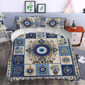 Blue and gold evil eye duvet cover styled in a bedroom with floral and hamsa details