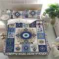 Ornate evil eye bedding set displayed in a bright bedroom with blue floral and hamsa artwork
