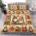 Gnome duvet cover set displayed on a bed with fall harvest artwork, pumpkins, mushrooms, leaves, and rustic accents