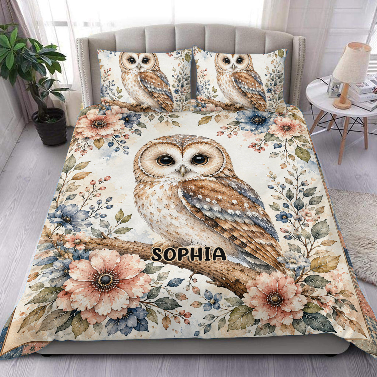 Owl duvet cover set with floral branches and a large illustrated owl displayed on a bedroom bed