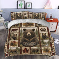 Rustic bear bedding set styled in a bedroom with woodland artwork, pinecones, leaves, and forest landscape panels