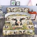 Dairy cow duvet cover set styled in a bedroom with floral countryside artwork and farmhouse decor