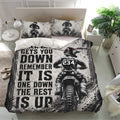Black-and-white motocross duvet cover set displayed on a modern bedroom with dirt bike artwork