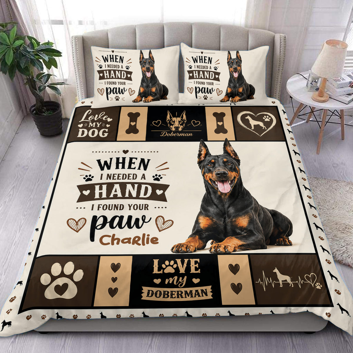 Doberman duvet cover set displayed on a bed with black and tan dog artwork, paw prints, hearts, and bold lettering