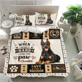 Doberman bedding set displayed in a bright bedroom with matching dog portrait pillowcases and bold black and tan panels